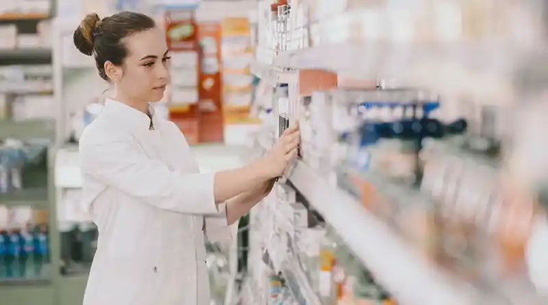 Pharmacy professional selecting products in a pharmacy